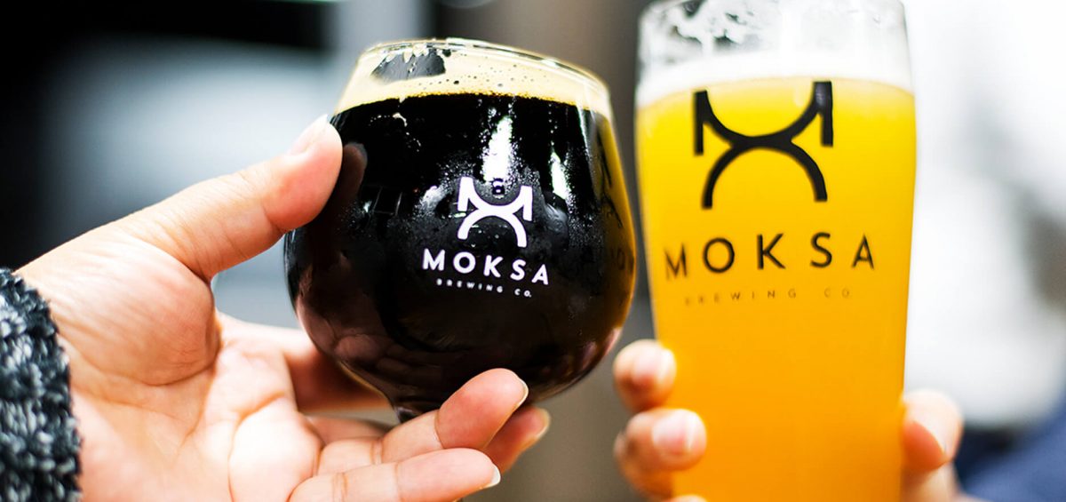 Moksa Brewing Co two glasses cheering
